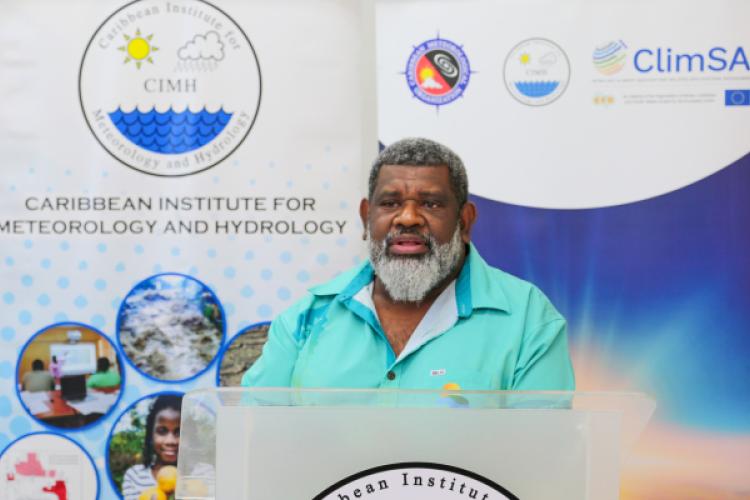 Mr Salesa Nihmei, Director of the new Climate Science & Information Programme at SPREP. In the background are pull up banners about the projects.