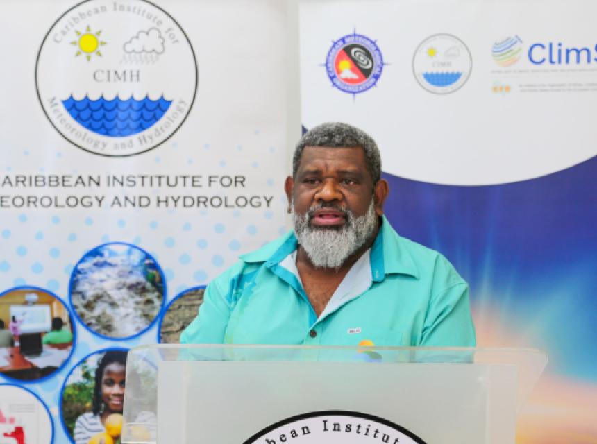 Mr Salesa Nihmei, Director of the new Climate Science & Information Programme at SPREP. In the background are pull up banners about the projects.